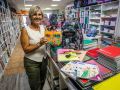 Fina Puñal, de la librería Clunia, junto a material escolar y libros