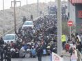 Traslado de migrantes asentados en la playa de Benítez, este viernes