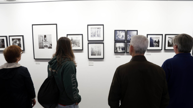Varias personas ven imaxes da exposición 'Viaxe ao Mictlán'