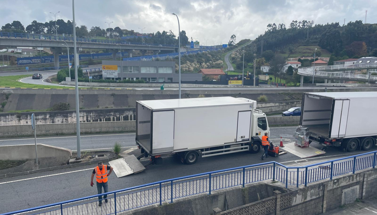 Camones cargando la mercancía del trailer averiado