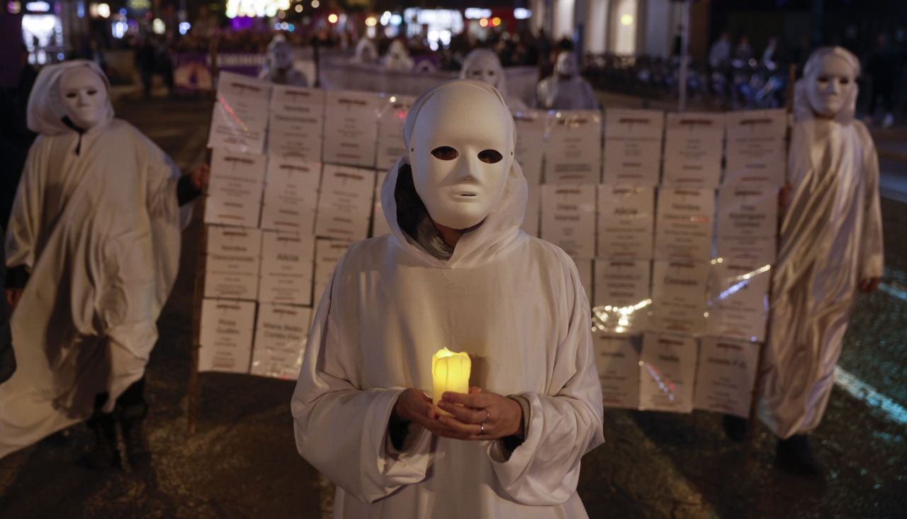 Una manifestante recorre las calles de Valencia recordando los nombres de las asesinadas por violencia de género en España