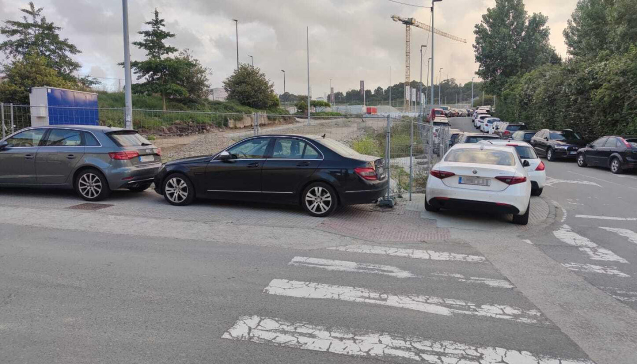 Imagen de varios vehículos ocupando una acera del barrio