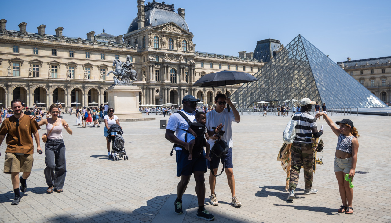 Personas caminan por la zona del Louvre en París
