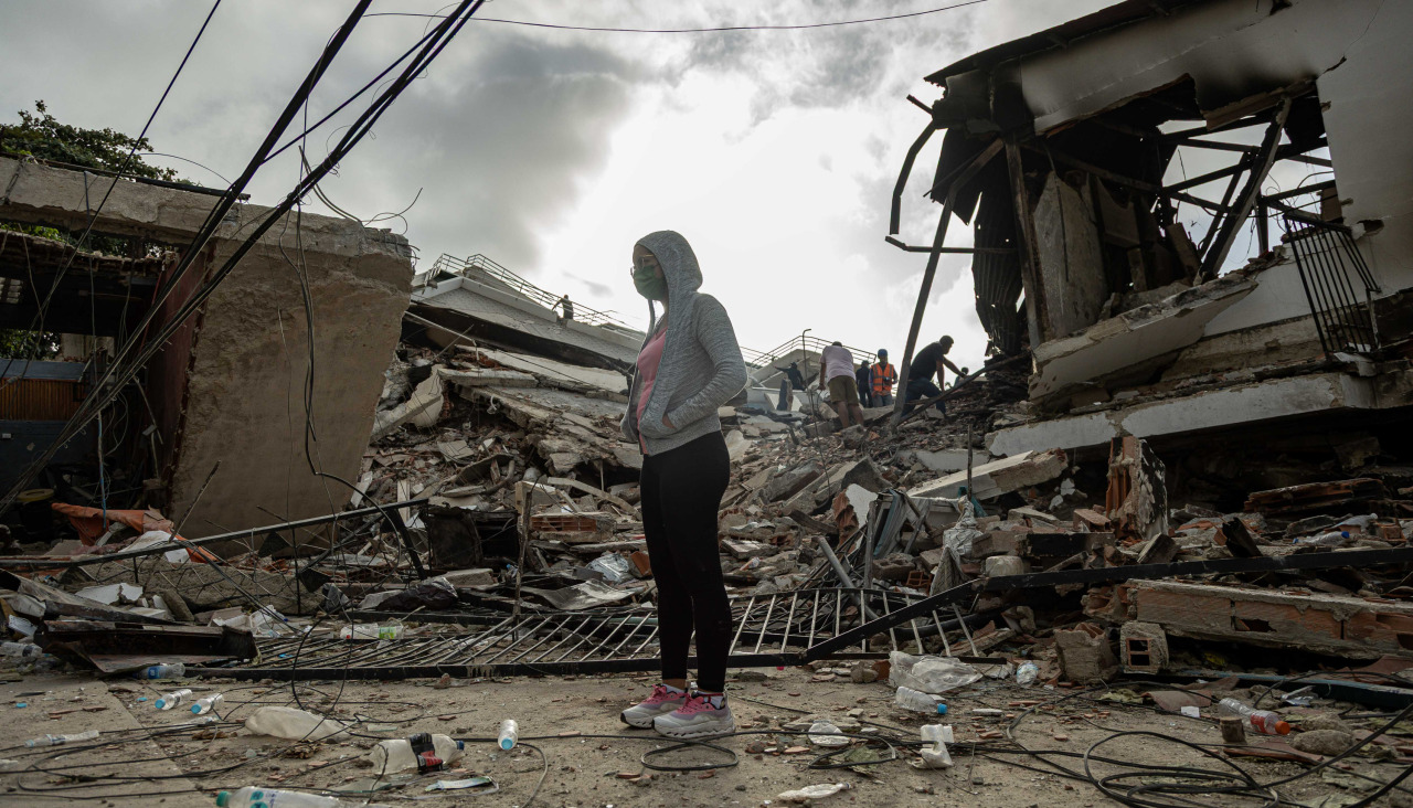 Una mujer espera frente a un edificio afectado por un terremoto en Venezuela