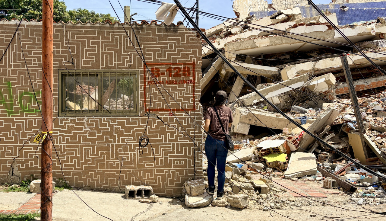 Una persona observa escombros de una edificación derrumbada por terremotos en La Guaira