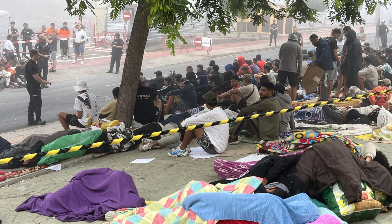 Migrantes siguen concentrados en las inmediaciones de la explanada de embolsamiento de Loma Colmenar de Ceuta este miércoles con la esperanza de conseguir una plaza en un nuevo centro de acogida